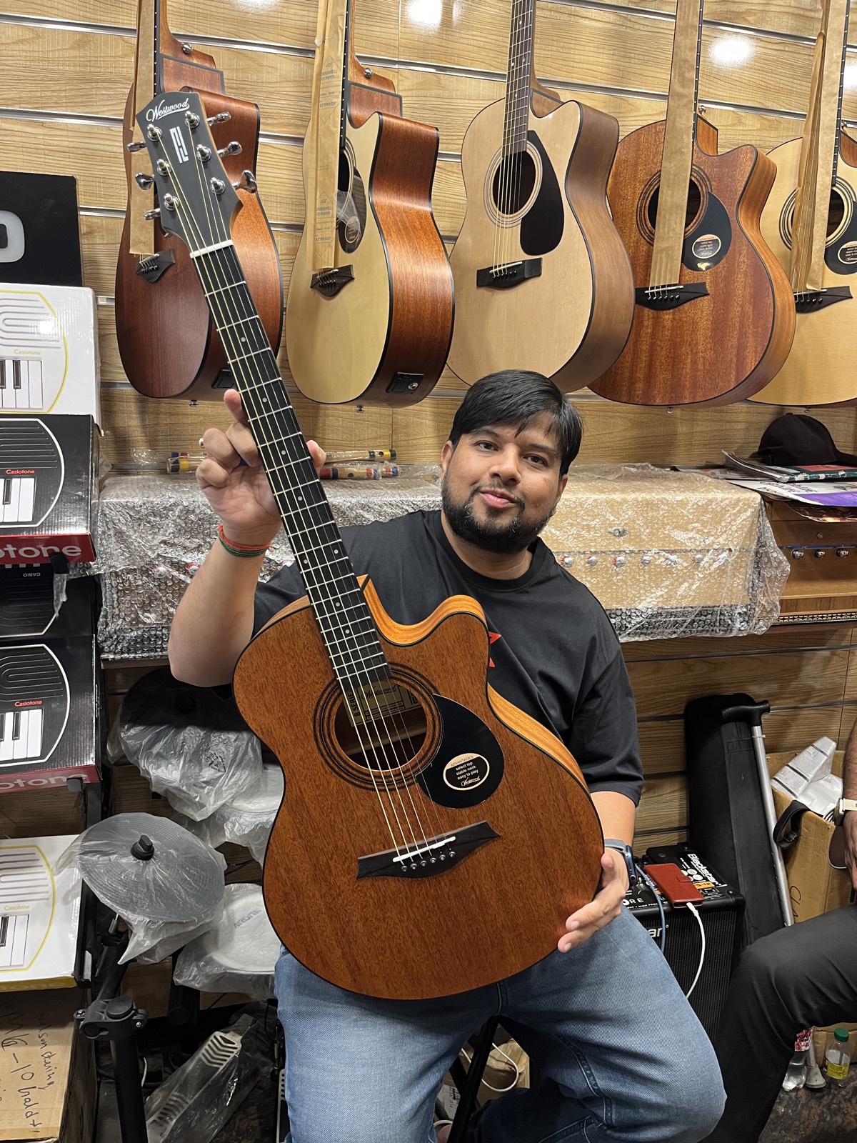 Tej Gupta, founder and lead instructor, holding an acoustic guitar